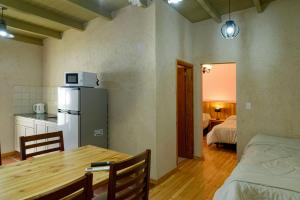 a kitchen and dining room with a table and a refrigerator at Apartamentos Siete Cavas in Bahía Blanca