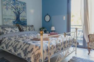 a bedroom with a bed with a blue wall at Country house 2 in Ktistádes