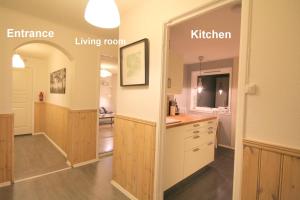 a kitchen with a sink and a mirror at Herøya Porsgrunn Apartment in Porsgrunn +5 photos