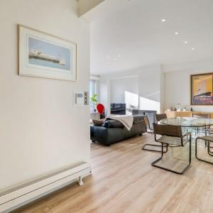 a living room with a table and a couch at Unique Seaview close to Casino - garage available - "Monte Carlo" in Ostend