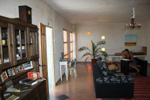 a living room with a person sitting in a chair at Los Bellidos de Alcandora in Sorvilán