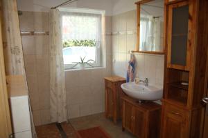 a bathroom with a sink and a window at Ruegen_Fewo 279_1 in Putbus
