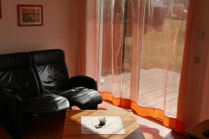 a living room with a chair and a table and a window at Ruegen_Fewo 279_1 in Putbus