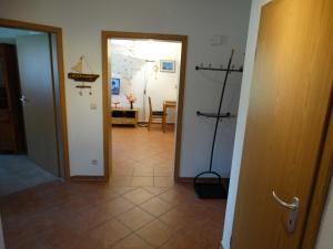 a hallway with a door and a room with a table at Ruegen_Fewo 279_1 in Putbus