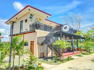 a house with a staircase in front of it at Gem's Paradise Resort in Cebu City