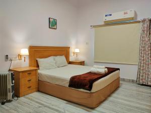 a bedroom with a large bed and a window at Homestay at Bungalow 97 Ajmer in Ajmer