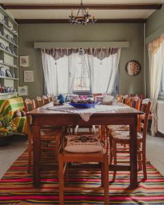 a dining room with a wooden table and chairs at Country House in Ktistádes