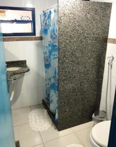 a bathroom with a shower and a toilet at Pousada Canto do Mar Ilha Grande in Praia de Araçatiba