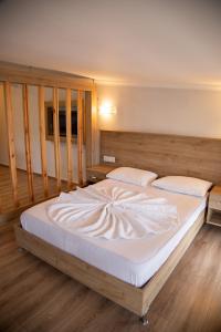 a bedroom with a large bed with white sheets at Amsterdam Otel & Suite Apart in Kemer