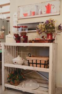 a wooden shelf with dishes and flowers on it at Country House in Ktistádes
