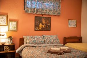 a bedroom with a bed and a painting on the wall at Country House in Ktistádes