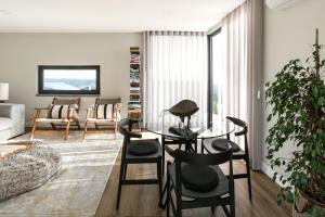 a living room with a glass table and chairs at Moinho Pangeia in São Martinho do Porto