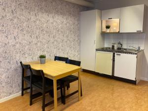 a kitchen and dining room with a table and chairs at Kuttainen Lodge in Karesuando