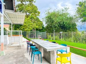 a large concrete table with colorful chairs in a yard at Kluang Swimming Pool Blues 11 Retro Homestay in Kluang