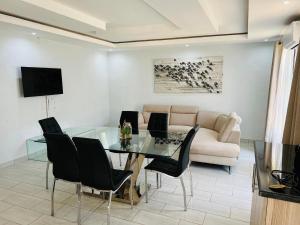 a living room with a glass table and a couch at THE BRIDGE BOUTIQUE LODGE in Moletlane
