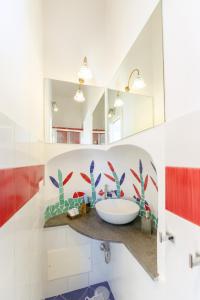 a bathroom with a sink and a mirror at TORRETTA CORRICELLA- Torretta in Procida