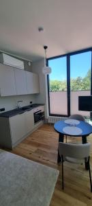 a kitchen with a blue table and a blue table and a table at Vallikraavi Penthouse in Tartu