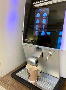 a cup of coffee in a coffee machine at Kuttainen Lodge in Karesuando