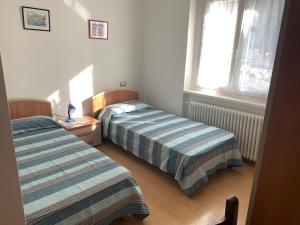 A bed or beds in a room at Angeli Dolomiti House2