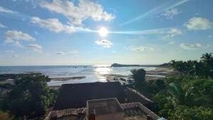 a view of the beach from the balcony of a resort at Bhavani Residency in Dapoli
