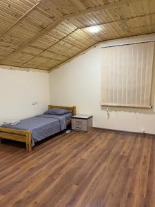 a bedroom with a bed and a large window at NUR TOON in Areni