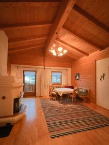 a large living room with a table and a rug at Schulhaus Tirol in Zell am Ziller