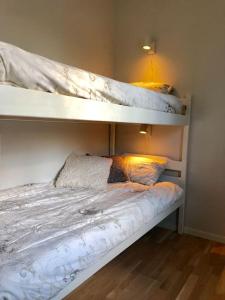 two bunk beds with pillows on them in a bedroom at Cottage by the river in Avesta