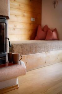 a bedroom with a bed and a cup on a table at Schulhaus Tirol in Zell am Ziller