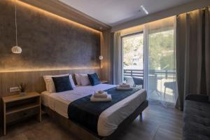 a bedroom with a bed and a large window at Nicole Studios in Agia Effimia