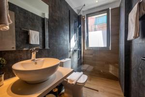 a bathroom with a bowl sink and a shower at Nicole Studios in Ayia Evfimia