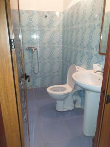 a bathroom with a toilet and a sink at Guest House Imdoukal in Aït Tamellil