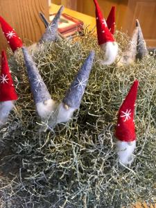 a group of gnomes in a nest with christmas hats at Baeren Hotel, The Bear Inn in Wilderswil