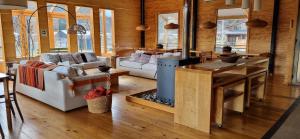 a living room with couches and a fireplace at Rumbo Sur Hotel in Villa O'Higgins