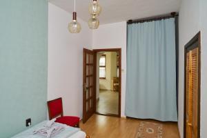 A bed or beds in a room at Kölcsey Vendégház