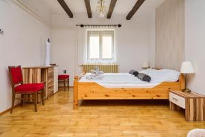 A bed or beds in a room at Kölcsey Vendégház