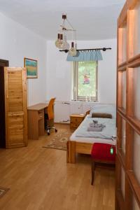 A bed or beds in a room at Kölcsey Vendégház