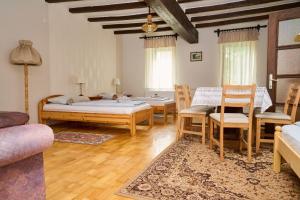 A bed or beds in a room at Kölcsey Vendégház