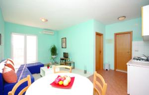 a living room with a table with a bowl of fruit on it at Apartments Makarska in Makarska