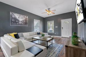 a living room with a white couch and a table at Wonderful 3 Bed 2 Bath House in Heart of YBOR City in Tampa