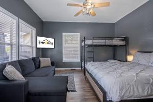 a bedroom with a bed and a couch at Wonderful 3 Bed 2 Bath House in Heart of YBOR City in Tampa