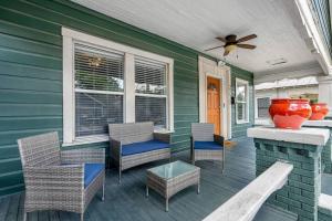 a porch with chairs and a fireplace and a fan at Wonderful 3 Bed 2 Bath House in Heart of YBOR City in Tampa
