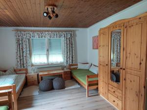 a bedroom with a bed and a desk and a window at Haus Grünwald in Gosau