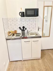Kuchyňa alebo kuchynka v ubytovaní Studios charmants cosy à 5 minutes du centre-ville