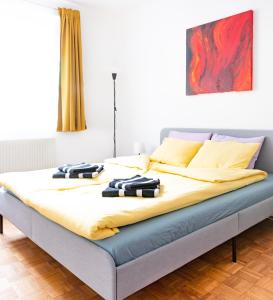 a bed with towels on it in a bedroom at Pal's Favoriten Apartment in Vienna