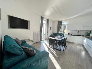 a living room with a blue couch and a table at Belvedere 229 Lakeview Apartment in Ghiffa