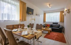 a living room with a dining table and a couch at Apart Blassnig in Maurach