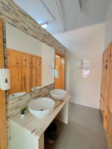 a bathroom with two sinks on a wooden counter at Kali Vice Surf Villa in Costa da Caparica