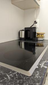 a kitchen with a black counter top with pots and pans at Charming Minusio Apartment, close to Locarno&Lake in Minusio