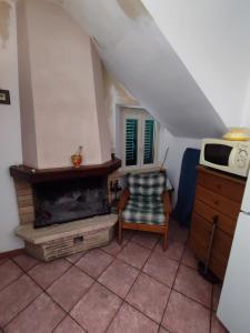 sala de estar con chimenea y microondas en Casa Vacanza Nonna Maria, en Calvi dellʼ Umbria