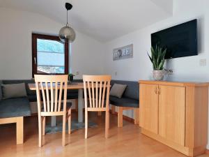 a living room with a dining room table and chairs at Haus Gumpold 2 in Wagrain